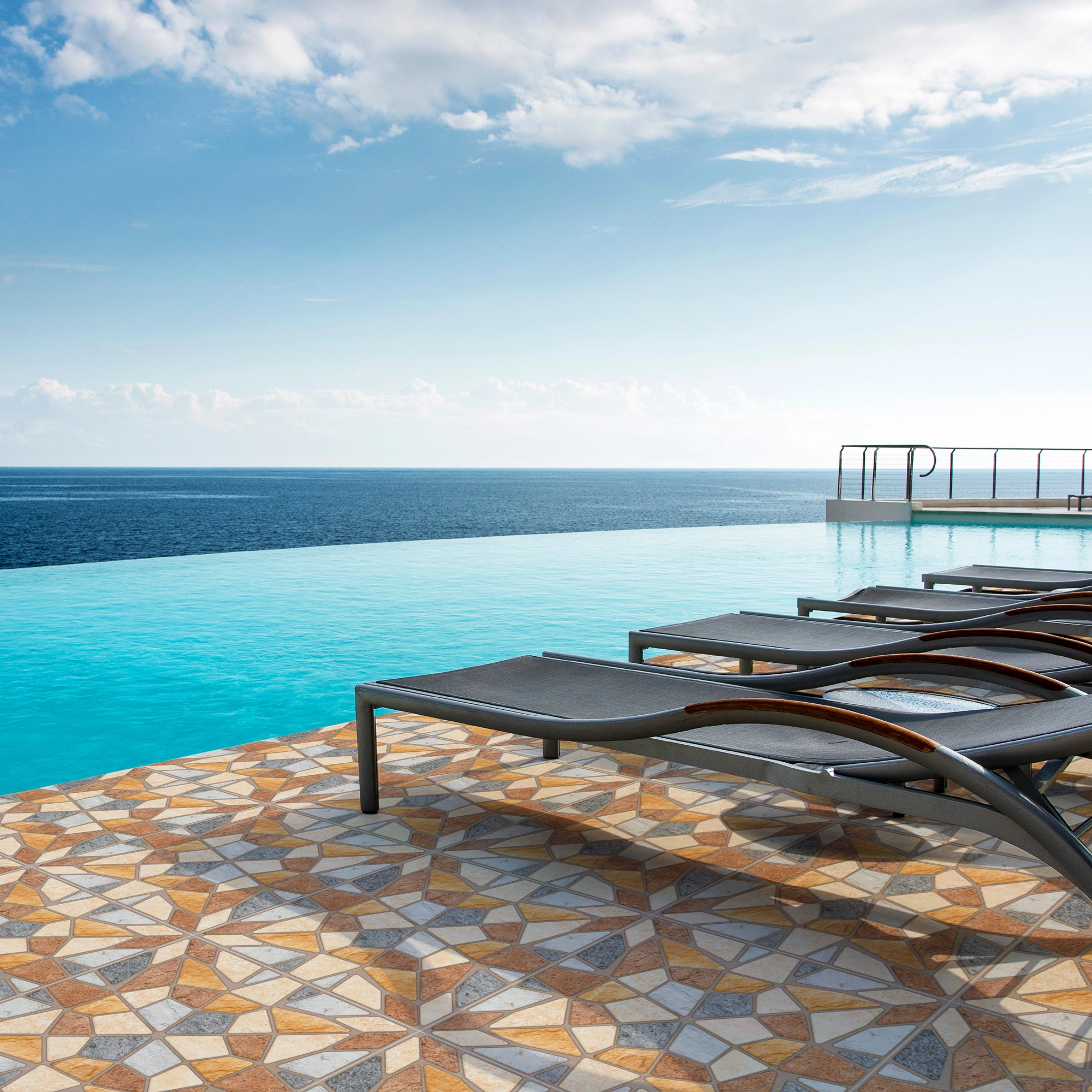 Piscina vista al mar, ambiente soleado, asientos negros y piso de cerámica piedra Artexa, colección Ecos, Cerámicos Gala